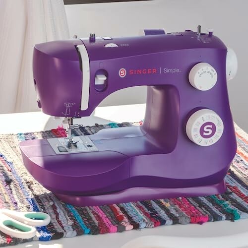 Purple Singer sewing machine on a colorful mat.