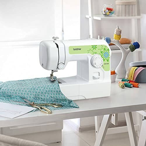 Sewing machine on a table with fabric and sewing supplies