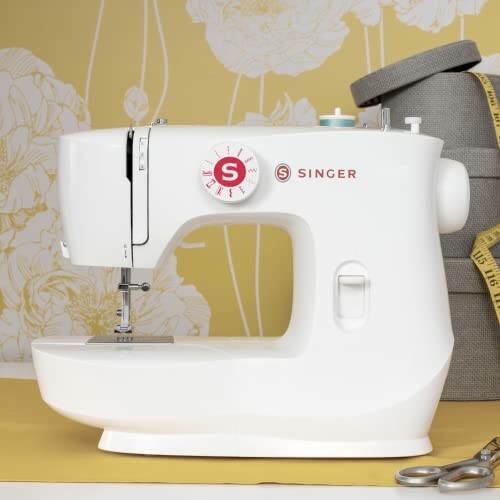 White Singer sewing machine on a yellow floral background